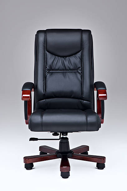 Black leather office chair. Executive black leather office chair over white ground with wooden handles and legs. office chair stock pictures, royalty-free photos & images