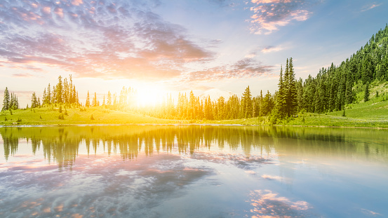 Beautiful morning scenery of River and mountain in a dramatic sky, the magic of sunset and sunrise, with a symphony of colors - orange, red, blue, and yellow, a colorful horizon of nature