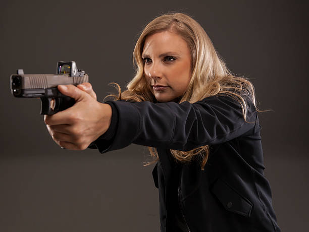 istock Woman aiming her gun. 488635940