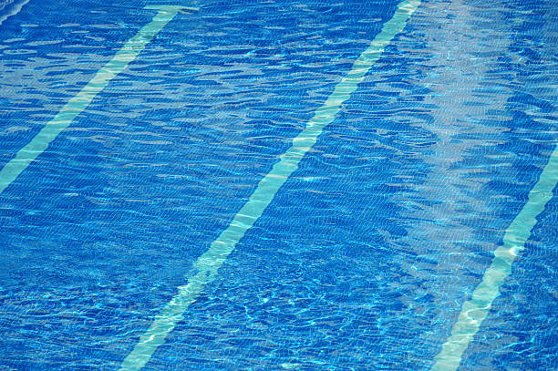 istock Clear blue water ripples in a swimming pool 488638702