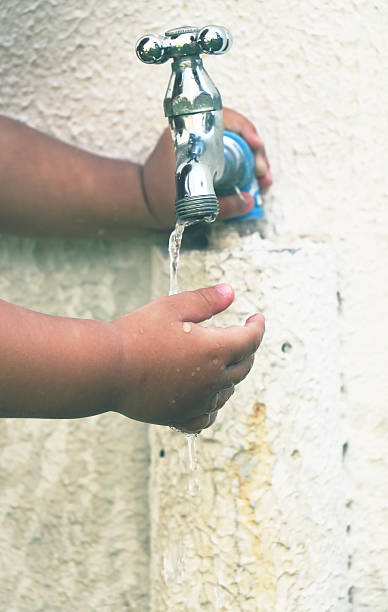 istock Faucet, water and toddler's hands 488641636