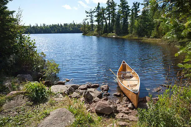 Photo of Fisherman's canoe on rocky shore in northern Minnesota lake