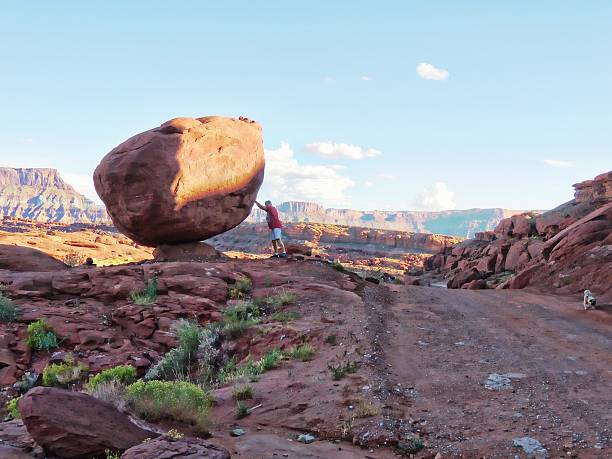 istock Man standing near a balancing rock 488646646