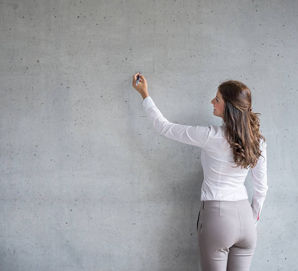 istock Business woman writing on a board 488649004