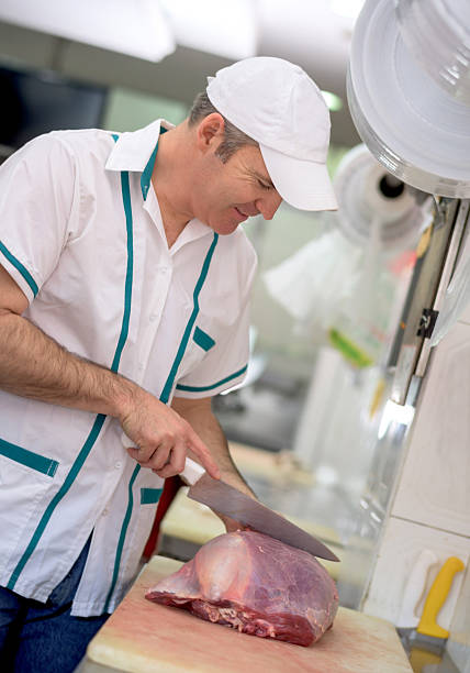 istock Butcher cutting the meat at the butchery 488649080