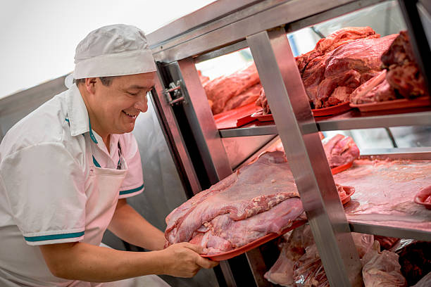 istock Butcher organizing meat at the butchery 488649268