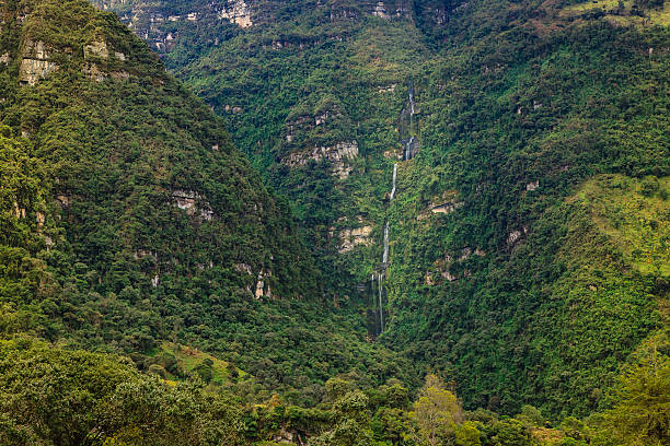 The waterfall known locally as Cascada La Chorrera near the town of Choachi in the Cundinamarca department of Colombia. Rock strata can be seen on the side of the mountain.  Photo shot in the morning sunlight at about midday; horizontal format.  No people. Copy space.