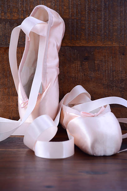 istock Pointe Ballet Shoes on dark wood background. 488651848