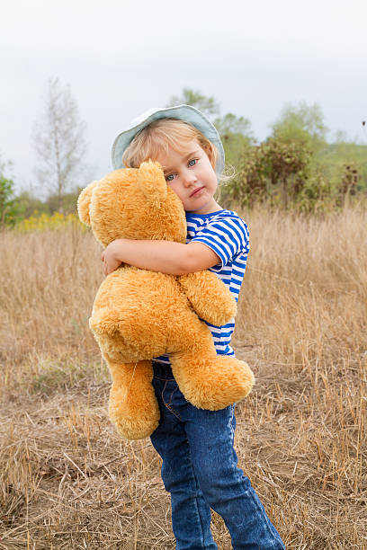 istock Cute little girl hugging a big Teddy bear 488652972