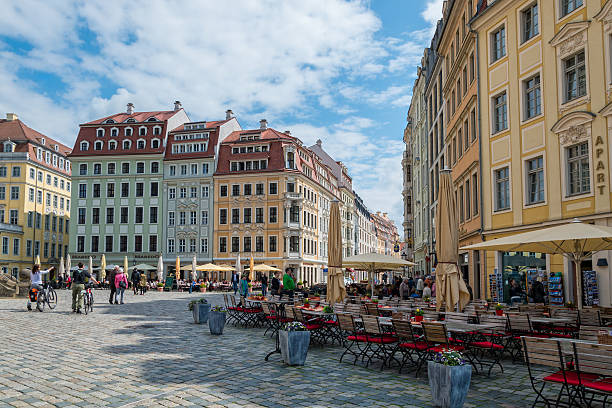 Historical center near Church of our Lady at Neumarkt square and summer outdoor cafes in historic downtown of Dresden in sunny day and blue sky, Germany
