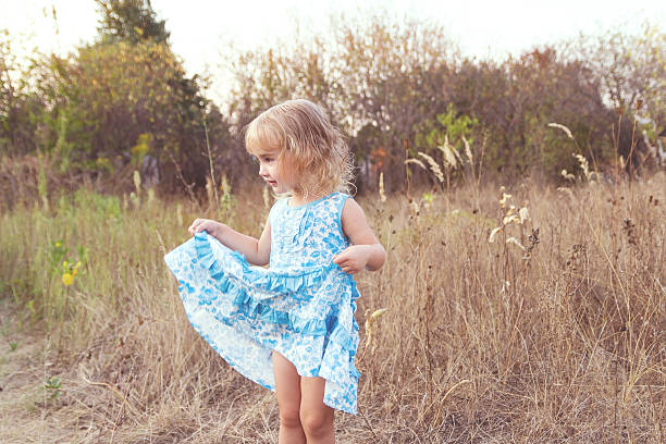 Funny girl dancing on the lawn at the farm.
