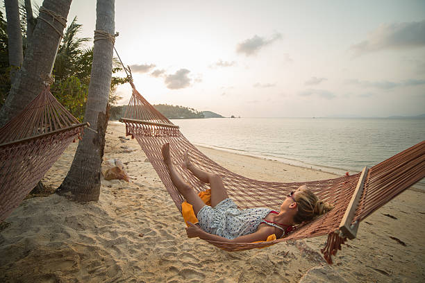 istock Young woman relaxing on hammock 488653267