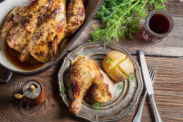 istock Roasted chicken and jacket potato served with wine 488653485