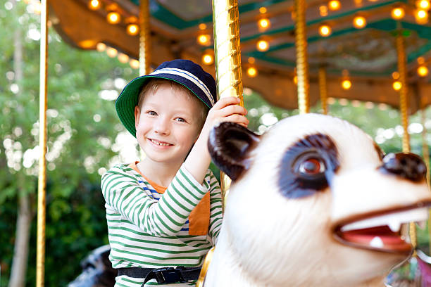istock kid at the merry-go-round 488655625