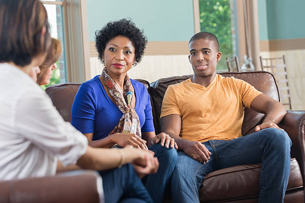 istock Mother and son listening to advice in support group 488657223