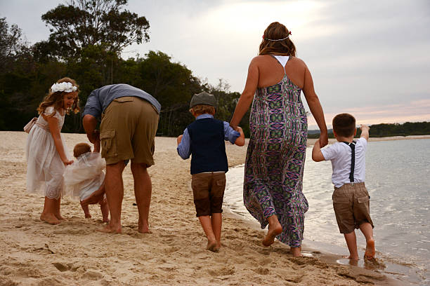 istock Family walking on beach together 488659914