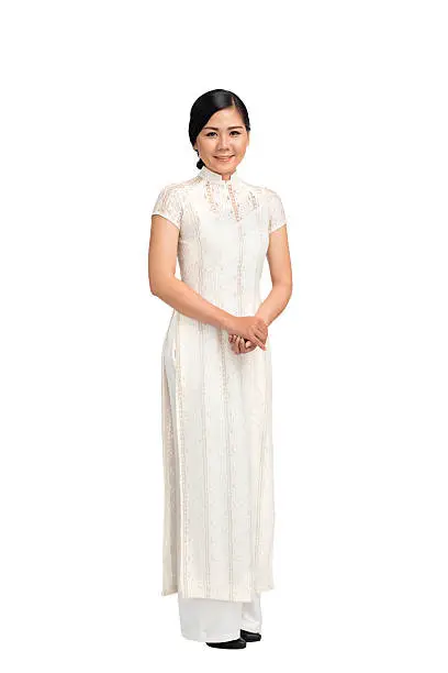 Full-length portrait of Vietnamese girl in ao-dai dress, isolated on white