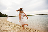 Little girl twirling and spinning at the beach