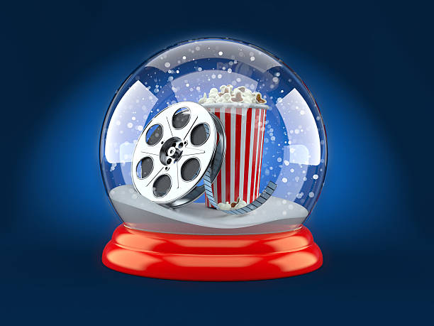 Christmas glass ball with film reel and popcorn stock photo