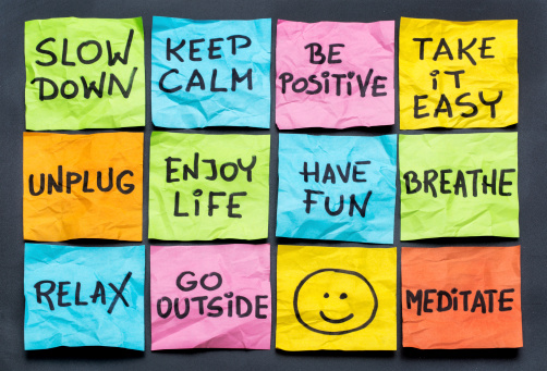 slow down, relax, take it easy, keep calm and other motivational lifestyle reminders on colorful sticky notes