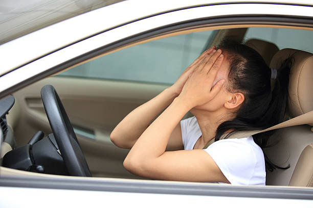 istock sad woman driver sit in car 488664911