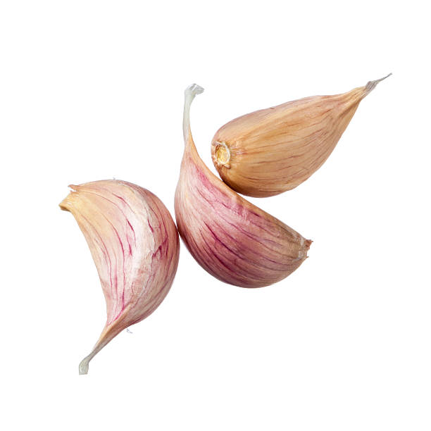 Three garlic cloves isolated on white background Three garlic cloves isolated on white background garlic clove photos stock pictures, royalty-free photos & images