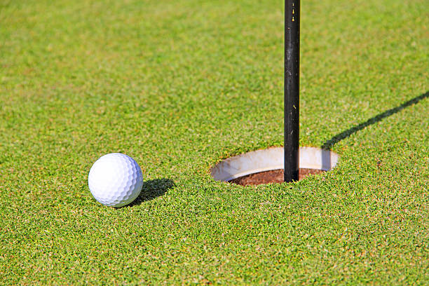 istock Golf ball on lip of cup 488667707