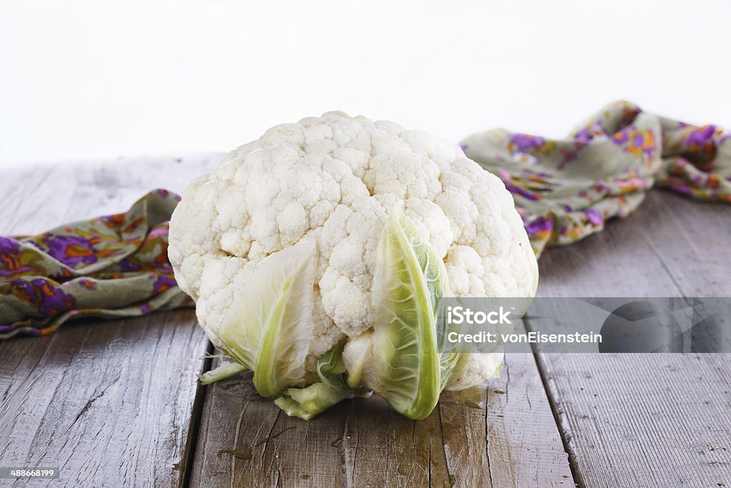 Single cauliflower on wooden background Single head of cauliflower on a rustic wooden background Agriculture Stock Photo