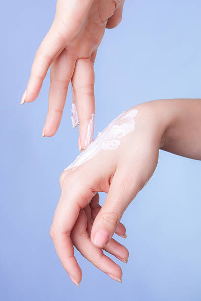 istock Skin care. Female palms with moisturizing cream. 488669135