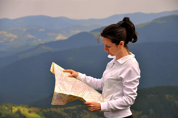 istock Girl tourist in mountain read the map. 488673314