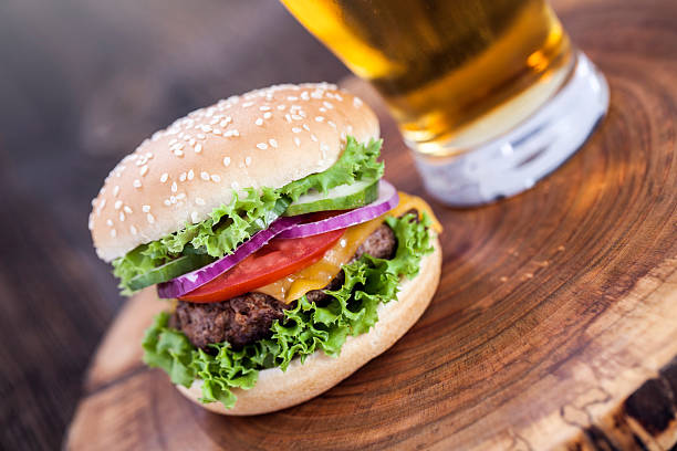 istock Beef burgers on a wooden board with chips and spices 488673426