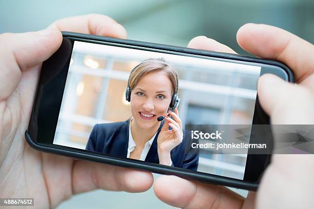 Male Hand Holding A Smartphone During A Skype Video Stock Photo - Download Image Now