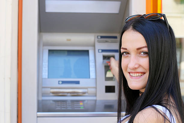 istock inserting a credit card to ATM 488675076