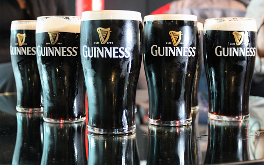 Dublin, Republic of Ireland - May 02, 2010: A few pints of Guinness standing on the table.