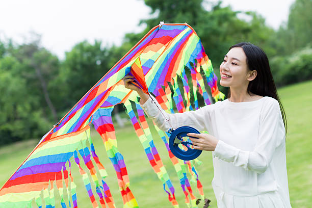 istock girl holding a kite 488676878