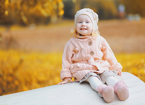 istock Cute little child wearing a knitted clothes having fun autumn 488687240