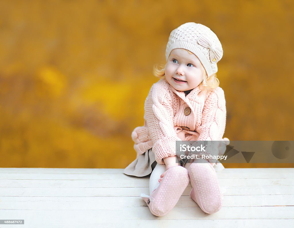 Sweet little child wearing a knitted clothes in autumn day 2015 Stock Photo