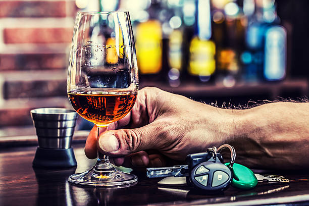 Cognac or brandy hand man the keys to the car Alcoholism. Cup cognac whiskey or brandy hand man the keys to the car and irresponsible driver. bar drink establishment stock pictures, royalty-free photos & images