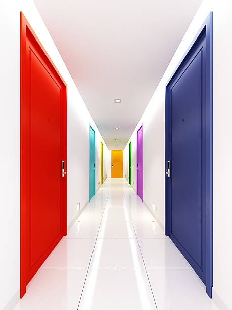 Teal doors in long curved alley. Corridor with coral walls. Interior of hostel.