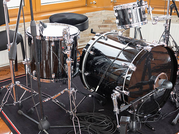 istock Black drum kit, cables and microphones closeup 488689116