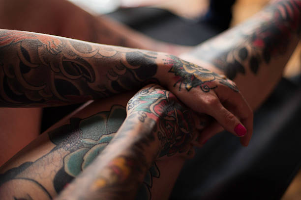 istock Close Up of Tattoos on Woman's Hands 488691730