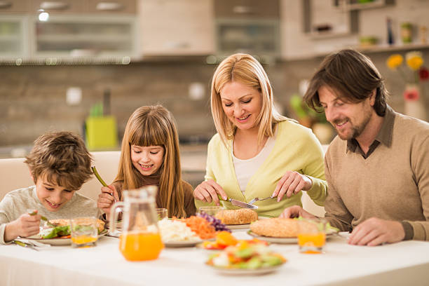 istock Smiling family having lunch together at home. 488691850