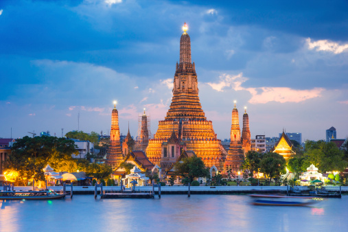 Wat Arun temple gold lighting after sunset with blue sky