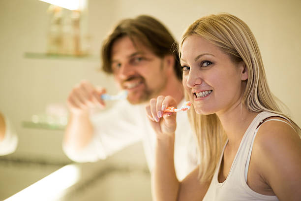 istock Smiling couple brushing teeth in the morning. 488692420
