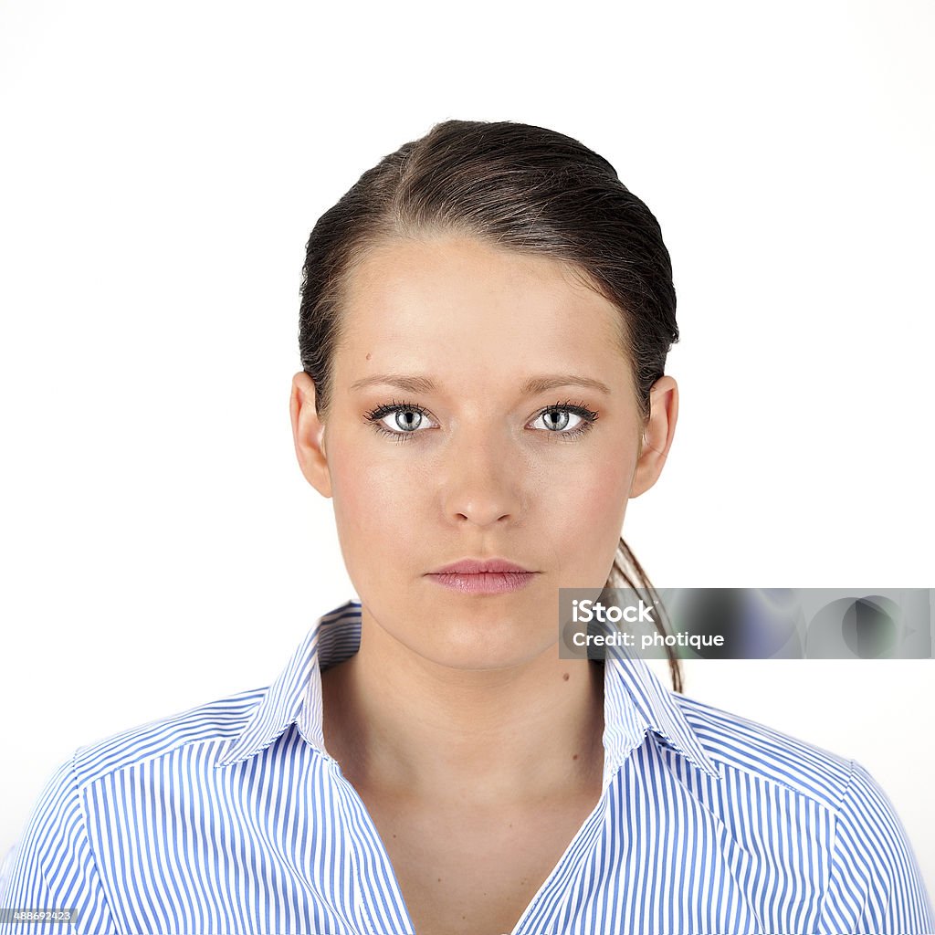 Portrait of a dark haired woman. Portrait of a woman with black hair in a pony tail, looking at the camera, against a white background. Very crisp photo with a larger depth of field. Photo Booth Picture Stock Photo