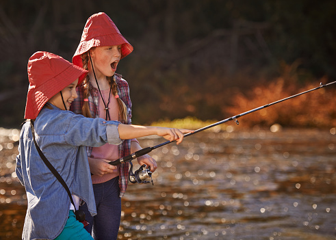 Shot of two young girls fishing by a riverhttp://195.154.178.81/DATA/i_collage/pi/shoots/805585.jpg