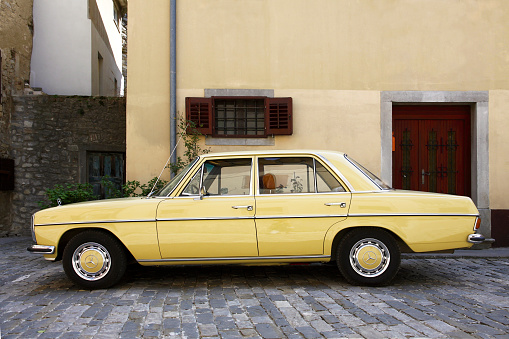 Buzet, Croatia - April 13, 2015: Mercedes-Benz 220D /8 Model W 114 (1968-1973) parked in the historic part of the city. Buzet, Croatia, Europe