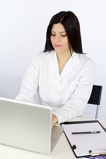 istock Female doctor working at desk with pc 488693847