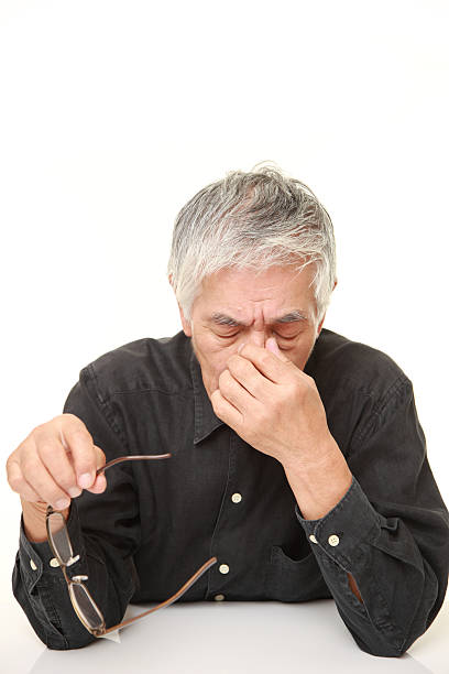 istock senior Japanese man suffers from Asthenopia 488693938