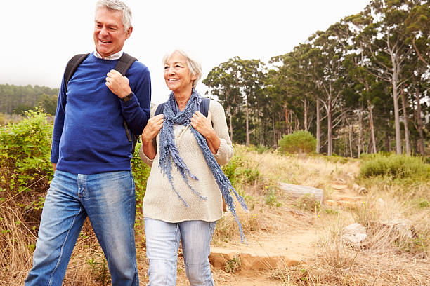 istock Senior couple walking together in a forest, close-up 488694364